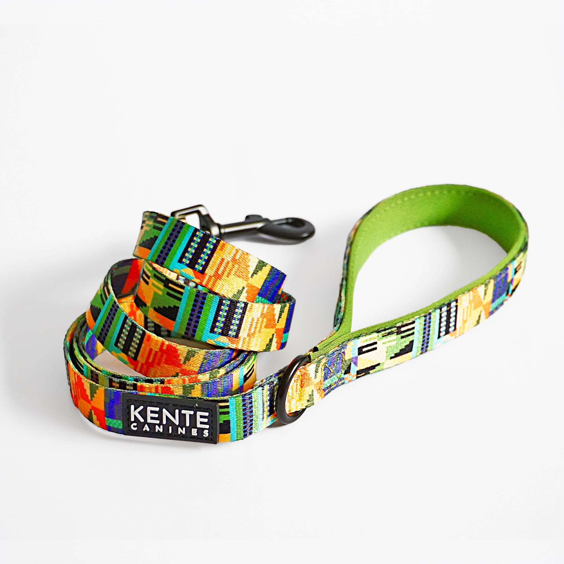 Kente Canines Jungle Green leash curled up with Kente pattern on a white background