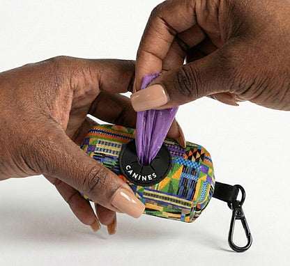 Kente Canines Jungle Green dog waste poop bag dispenser with a purple bag being pulled out, held by two hands.